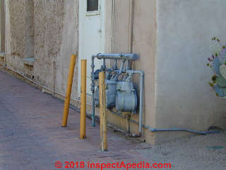Gas meter protected from vehicles along a drive or alley in Tucson (C) Daniel Friedman