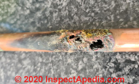 Large leak opening in a copper gas pipe (C) InspectApedia.com Joanne