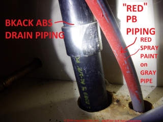 ABS (black) and probably PEX (red) drain and water supplyi piping photos (C) InspectApdia.com BnB Home Inspectins