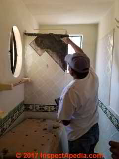 Squaring up shower enclosure wall to permit installing gasketed window and door (C) Daniel Friedman
