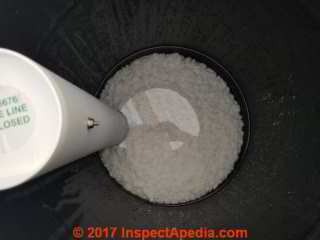 Water softener brine tank water level may be above the salt (C) Daniel Friedman at InspectApedia.com