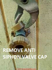 Removing the plastic cap on the Woodford Model 17 anti siphon valve (C) Daniel Friedman at InspectApedia.com