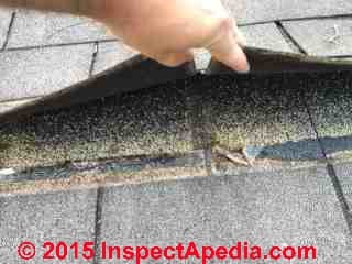 Asphalt shingle cellophane strip in the wrong place (C) A Kester InspectApedia.com