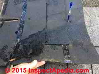 Mis-nailed asphalt shingle (C) A Kester InspectApedia.com