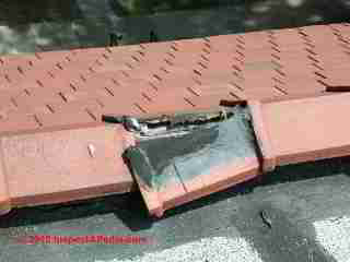 Broken ridge tile © D Friedman at InspectApedia.com 