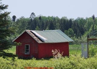 The up-wind side of metal roof buildings may need extra fasteners to avoid wind uplift that begins curling back the roof at that edge. (C) Daniel Friedman at InspectApedia.com