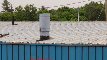Raised rib exposed fastener metal roof system with leaks at chimneys & plumbing vents (C) Daniel Friedman at InspectApedia.com