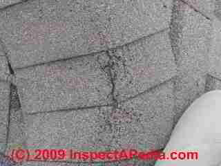 Roof ridge shingle cracking © D Friedman at InspectApedia.com 