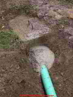 Photograph of repairs to a leak at the septic tank inlet port