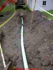 Photograph of installing plastic sewer drain line piping