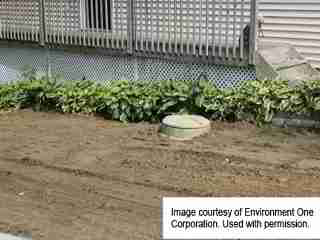 Environment One Sewage Pump Installed - exterior view (C) InspectApedia.com Environment One Corp