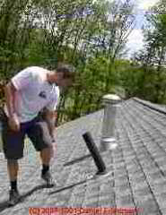 Photograph of a loose, improperly installed, slanted plumbing vent above the building roof