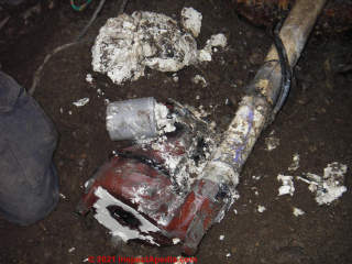 White waxy clog at sewage pump where a HE clothes washer is installe (C) InspectApedia.com John James