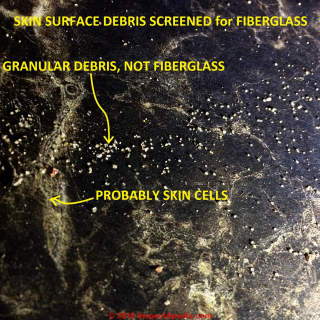 Granlular skin debris mistaken for fiberglass (C) InspectApedia.com Carol