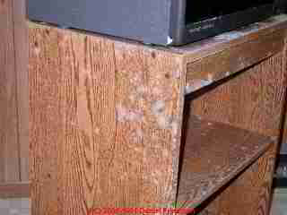 Photo of moldy TV stand in an upper floor den of a house subject to high moisture conditions
