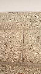 Vertical crack through new concrete block foundation wall (C) InspectApedia.com TyMatbo