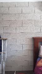 Vertical crack through new concrete block foundation wall (C) InspectApedia.com TyMatbo