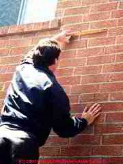 Photograph of structural damage to a brick wall