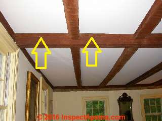 Splits in a ceiling beam © Daniel Friedman at InspectApedia.com