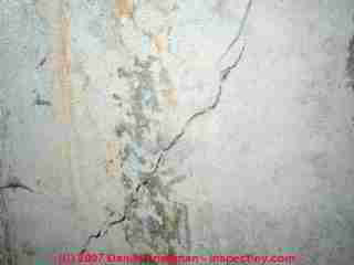 Photograph of diagonal cracking in poured concrete © Daniel Friedman at InspectApedia.com