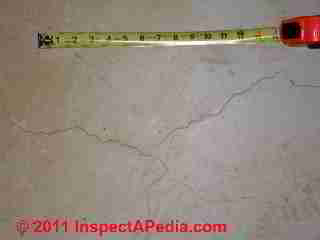 Hairline concrete slab cracks © Daniel Friedman at InspectApedia.com