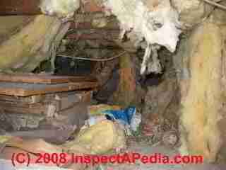 Contaminated insulation in a crawl space © Daniel Friedman at InspectApedia.com