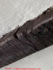 Crack across the wood grain in an antique wooden beam (C) InspectApedia.com Richard