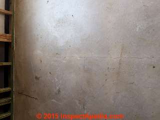 Long thin cracks in a Texas basement floor slab (C) InspectApedia BT