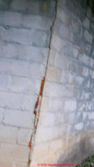 Foam-sealed vertical crack at block foundation corner is not a repair (C) InspectApedia.com Ulanda