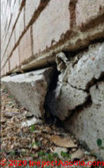 "Chipping" concrete foundation is actually broken and leaning (C) InspectApedia.com Chris