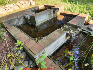 Frog pond in New York, constructed ca 2003 using treated lumber and structural wood framing screws (C) Daniel Friedman at InspectApedia.com