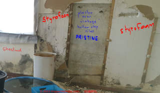 Partial demolition of moldy drywall shows no mold growth on plaster atop hollow clay block walls (C) InspectApedia.com Cheryl