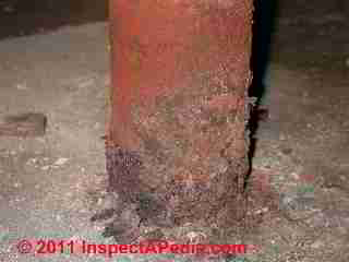Severe rust damage to steel column © Daniel Friedman at InspectApedia.com