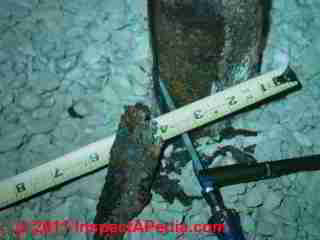 Severe rust damage to steel column © Daniel Friedman at InspectApedia.com