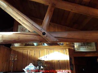 Significant checking cracks in log beams & truss components (C) BB InspectApedia.com
