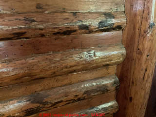 Wooden slats nailed between logs on interior wall of 1927 Log home in Oregon - probably covering insulation or chinking. (C) InspectApedia.com Sandie