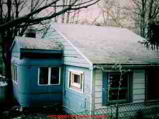 Photograph of  this much-modified trailer - this is not a modern mobile home. It was a camper, converted to use as a house, or perhaps an addition to a house.