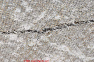 fibers in damaged painting backing board (C) InspectApedia.com Daniela