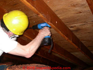 Drilling bolt holes to mount the roof de-sagging machine (C) Jess Aronstein Daniel Friedman InspectApedia.com