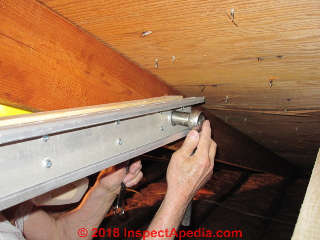 Roof sag expander being bolted at one end (C) InspectApedia.com Jess Aronstein Daniel Friedman