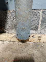Rust damaged steel lally columns in garage (C) InspectApedia.com SG/Anon