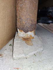 Rust damaged steel lally columns in garage (C) InspectApedia.com SG/Anon