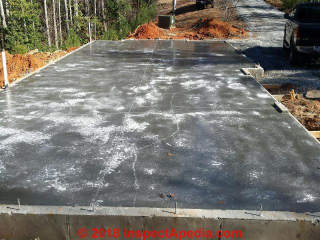Shrinkage cracks in a concrete slab poured in very cold weather (C) InspectApedia.com Nardslico