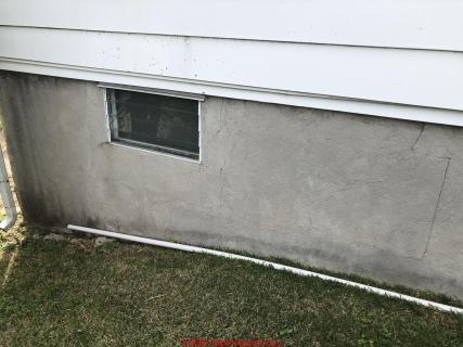 thin crack in concrete-parged foundation may hide more serious damage - or not (C) InspectApedia.com Chris