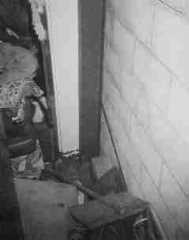 Photograph of Steel I-beams or U-channel beams placed against the bulged wall