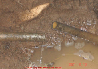Galvanized well pipe at pitless adapter (C) InspectApedia.com Paul F