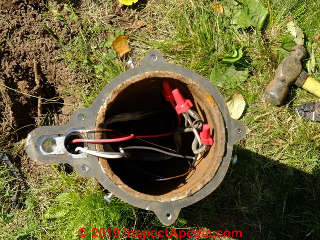 Submersible well pump wiring splices at the well casing top  (C) Daniel Friedman at InspectApedia.com