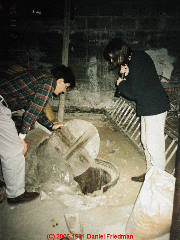 Antique well pump on steel casing under a home © D Friedman at InspectApedia.com 