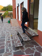 Open riser stair treads are unsafe if treads are not properly aligned, leaving open walking space (C) Daniel Friedman Lourdes Mexico at InspectApedia.com