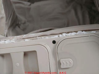 White fluffy powdery crystalline deposits on an air mattress: battery acid leak, not mold, not mineral effloresence (C) InspectApedia.com Church
